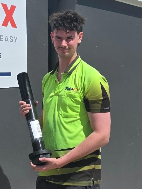 MEGAFIX team member holding a custom manufactured bolt