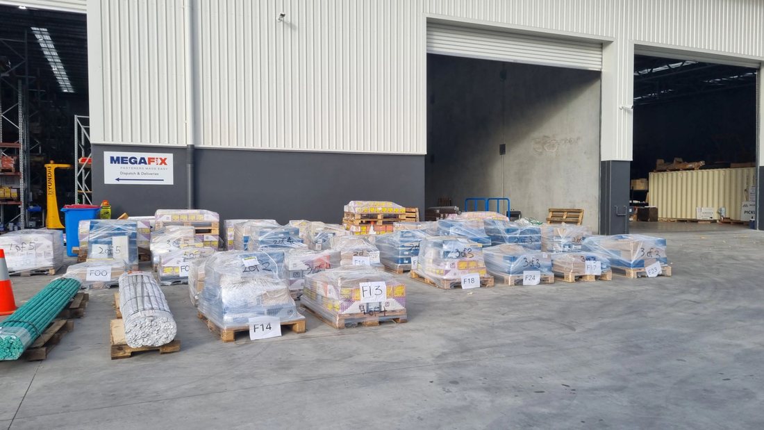 Project order pallets packed and labelled by site location, staged for dispatch at Bellevue